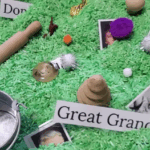 Nostalgia evoking items and pictures of ancestors nestled in green grains of rice encouraging hands-on family history.